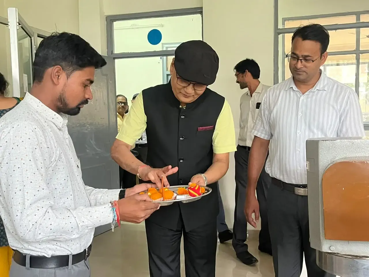 Siddhartha Institute of Pharmacy staff members celebrating Vishwakarma Pooja with devotion in Dehradun.