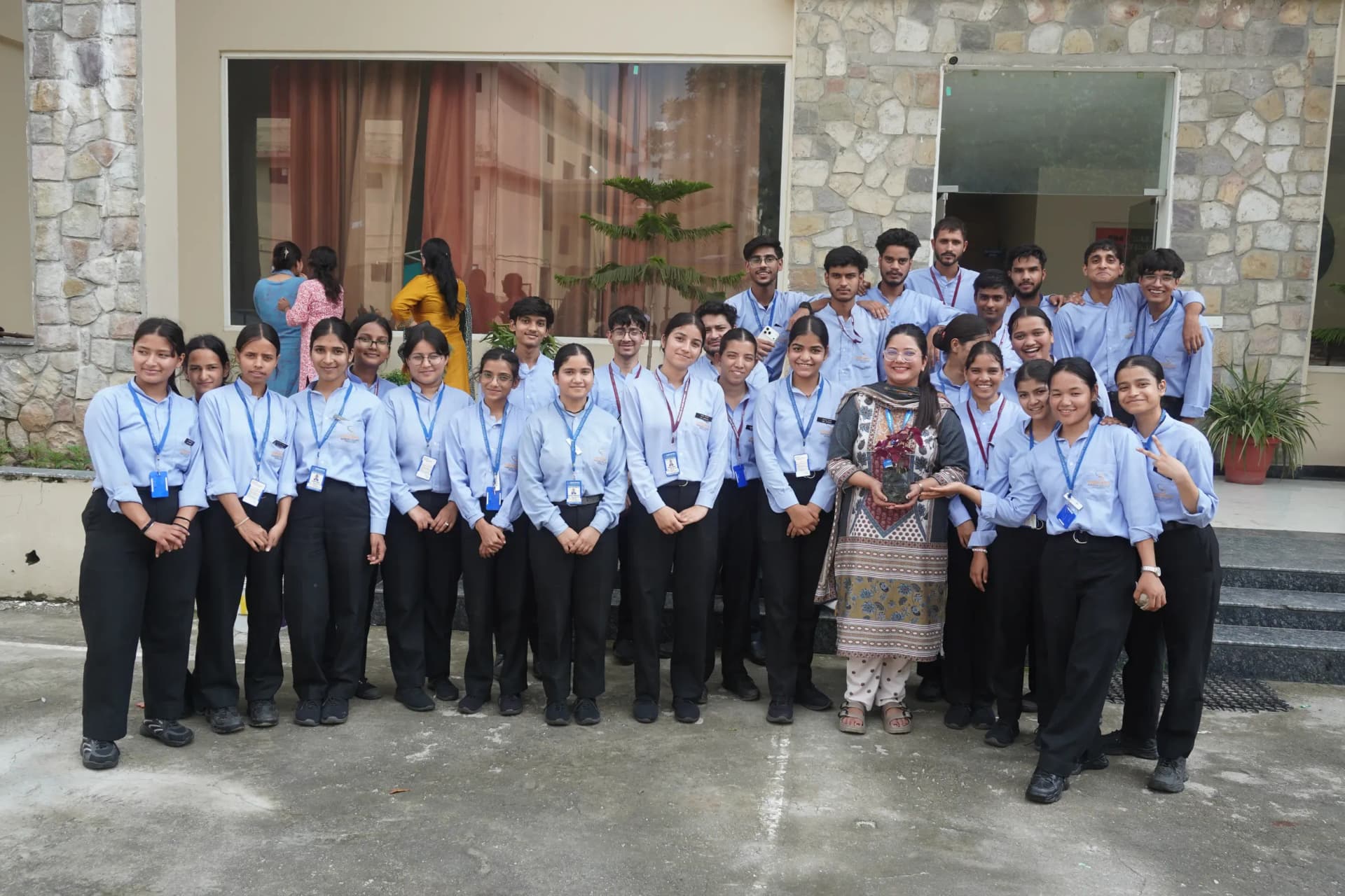 Students and faculty planting saplings during the Harela celebration at Siddhartha Nursing Education & Research Institute, Dehradun to support a greener future.